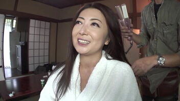 A stunning Japanese woman, an adult film star, splatters and has her face adorned with cum.