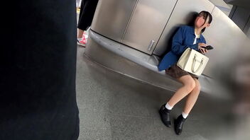 A young doll with dark-hued hair and a dark-hued mini-skirt walks around Shibuya, Japan.