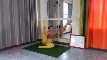 Regina Noir in yellow stocking doing yoga in a public gym.